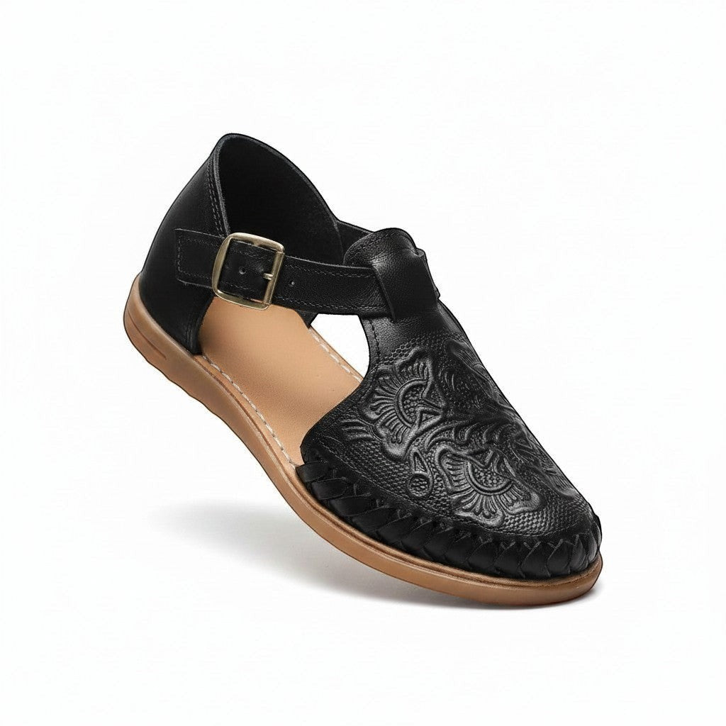 ARTESANALRENVAL black synthetic leather espadrille sandal with intricate floral embossing and buckle strap.
