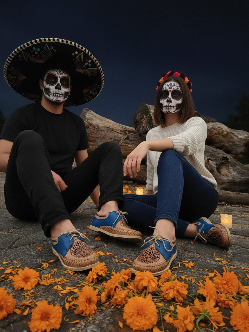 ARTESANALRENVAL blue and tan leather Catrina moccasins worn by a couple with Day of the Dead makeup in a festive setting