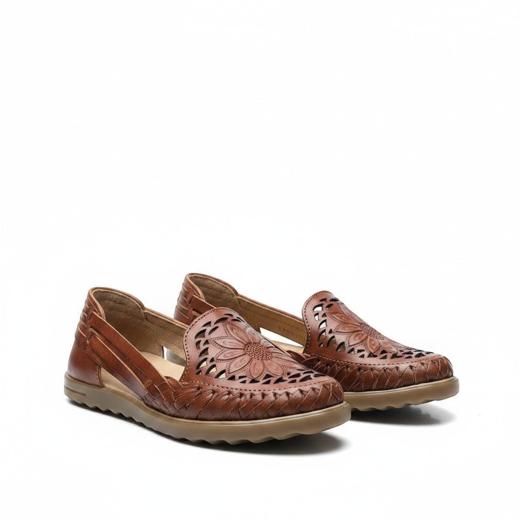 ARTESANALRENVAL brown leather huarache flats with floral cutouts and woven details. Comfortable, breathable, and handmade in Mexico.