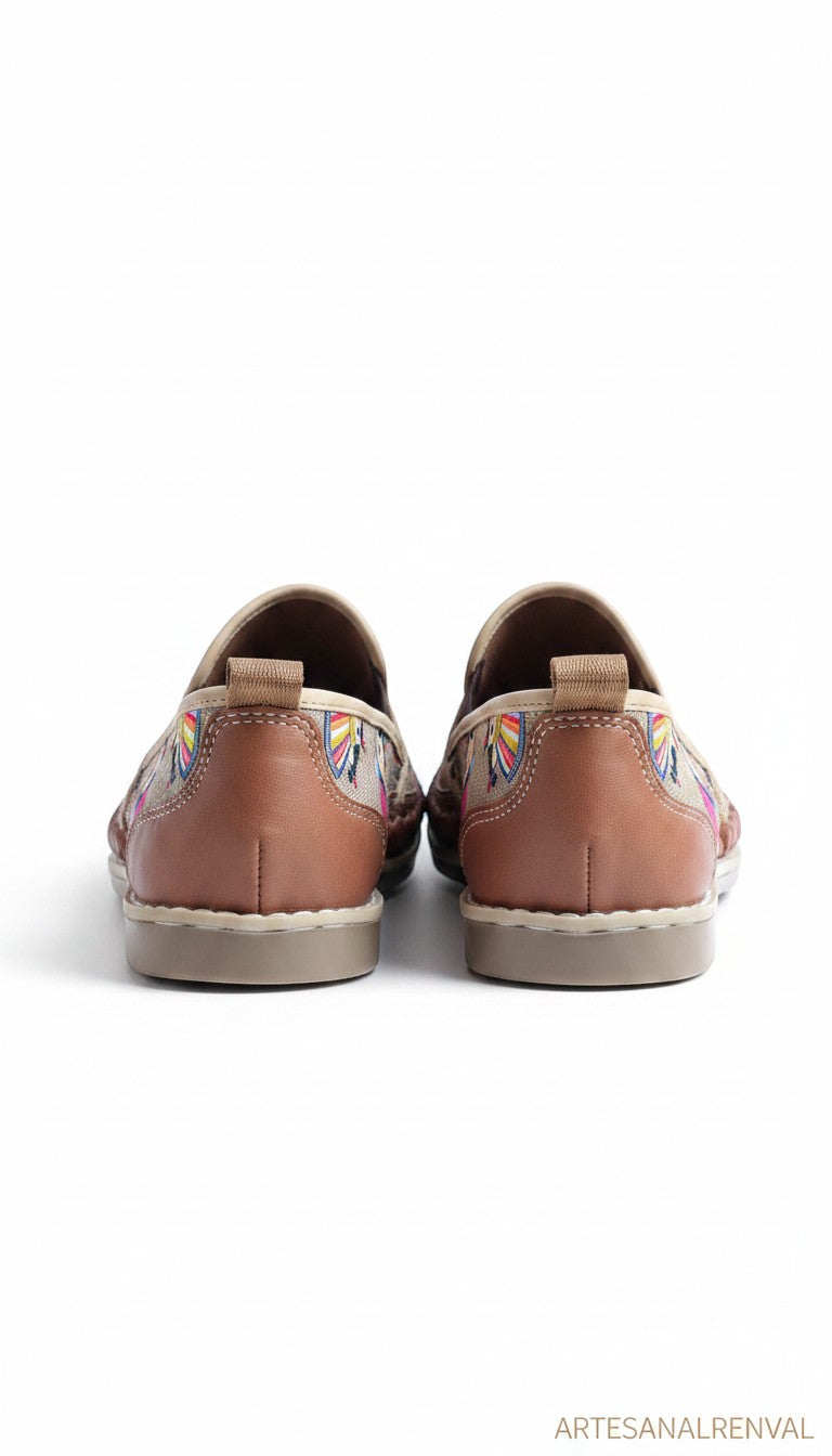 ARTESANALRENVAL brown leather huarache shoes with colorful Otomi embroidery of Mexican dolls.
