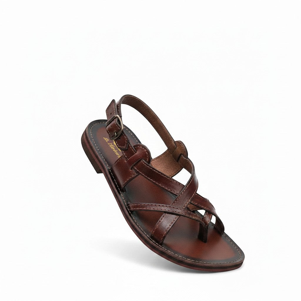 ARTESANALRENVAL brown leather huarache sandals with criss-cross straps and buckle closure.