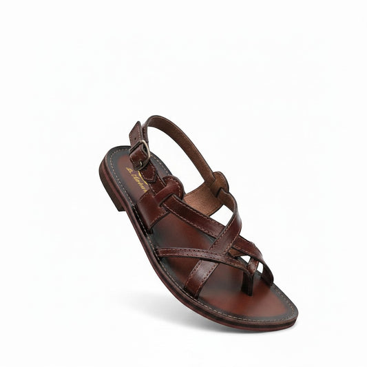 ARTESANALRENVAL brown leather huarache sandals with criss-cross straps and buckle closure.