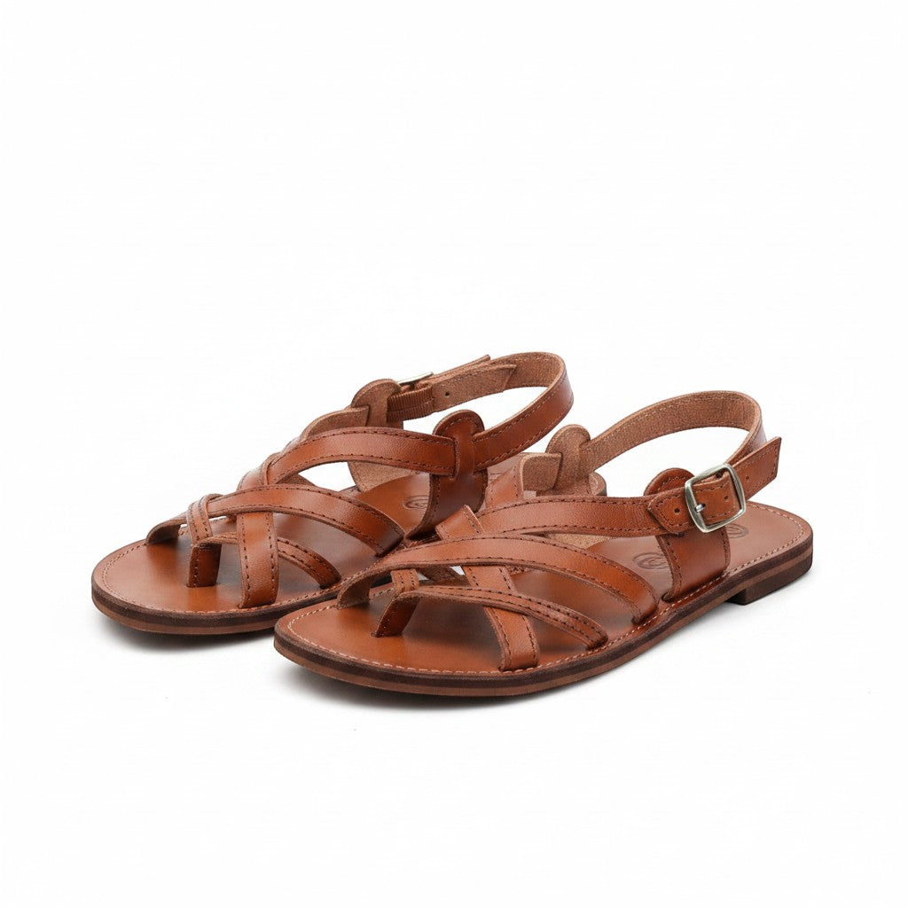 ARTESANALRENVAL brown leather gladiator huarache sandals with buckle closure and criss-cross straps.
