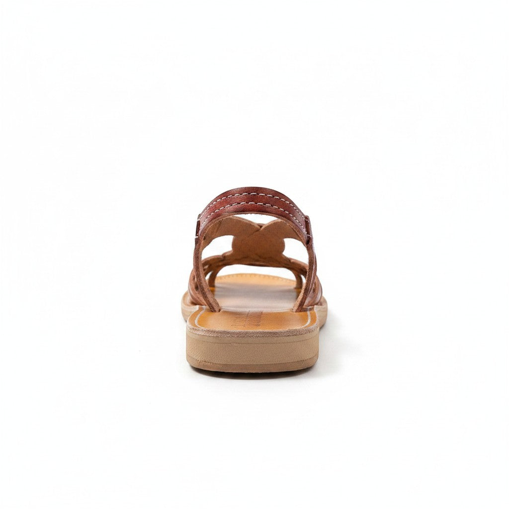 ARTESANALRENVAL brown leather huarache sandals with intricate cutout design and white stitching. Open-toe, flat sole.