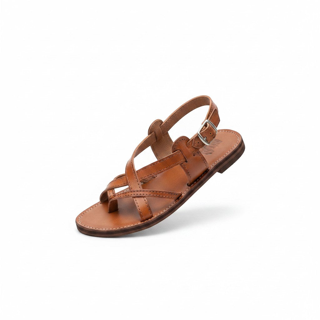 ARTESANALRENVAL brown leather huarache sandals with criss-cross straps and buckle closure.