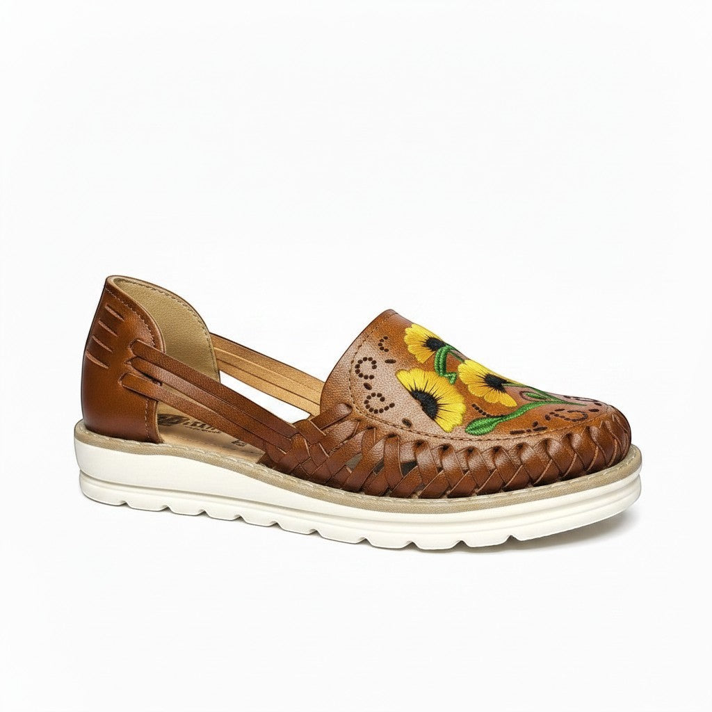 ARTESANALRENVAL brown leather huarache flats with embroidered sunflowers and woven detail.