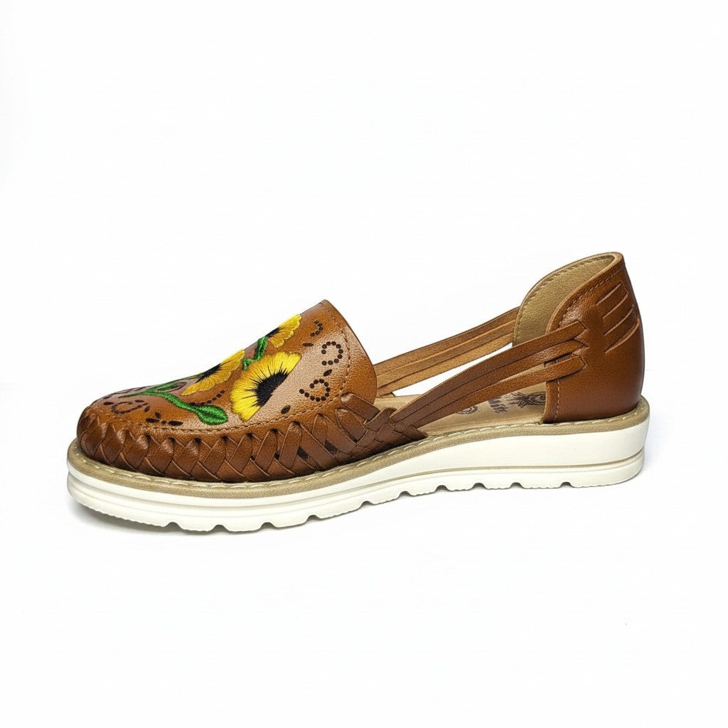 ARTESANALRENVAL brown leather huarache sandals with embroidered sunflowers and woven detail. Open heel and strap closure.