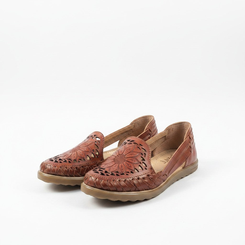ARTESANALRENVAL brown leather huaraches with floral cutouts and woven details. Comfortable, breathable, and handmade.