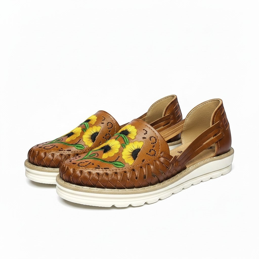 ARTESANALRENVAL brown leather huaraches with embroidered yellow sunflowers and cut-out details.