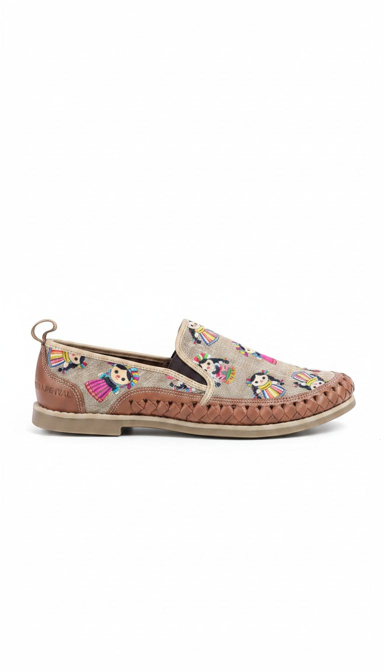 ARTESANALRENVAL tan leather huarache slip-on shoe with embroidered Mexican doll pattern and woven detail.