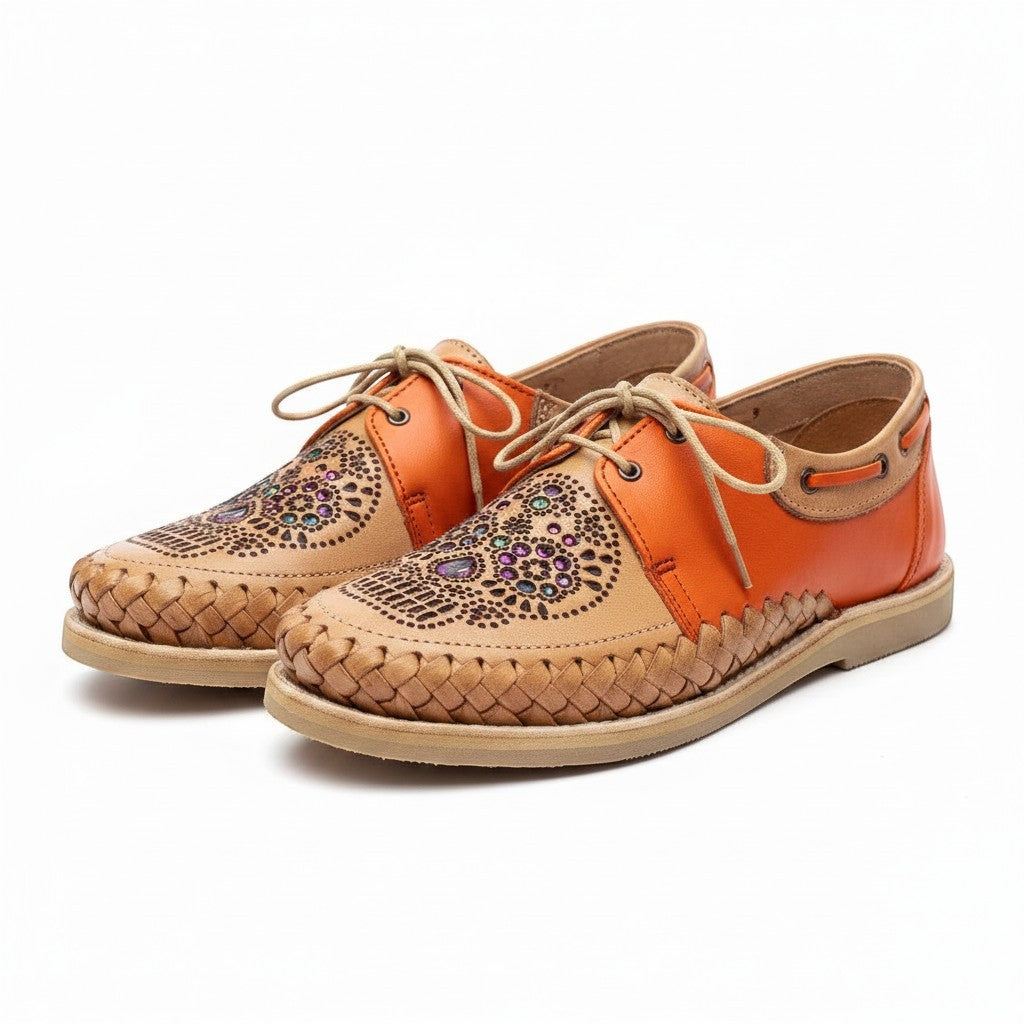 ARTESANALRENVAL handcrafted leather lace-up oxfords in orange and tan with intricate laser-cut and woven details.