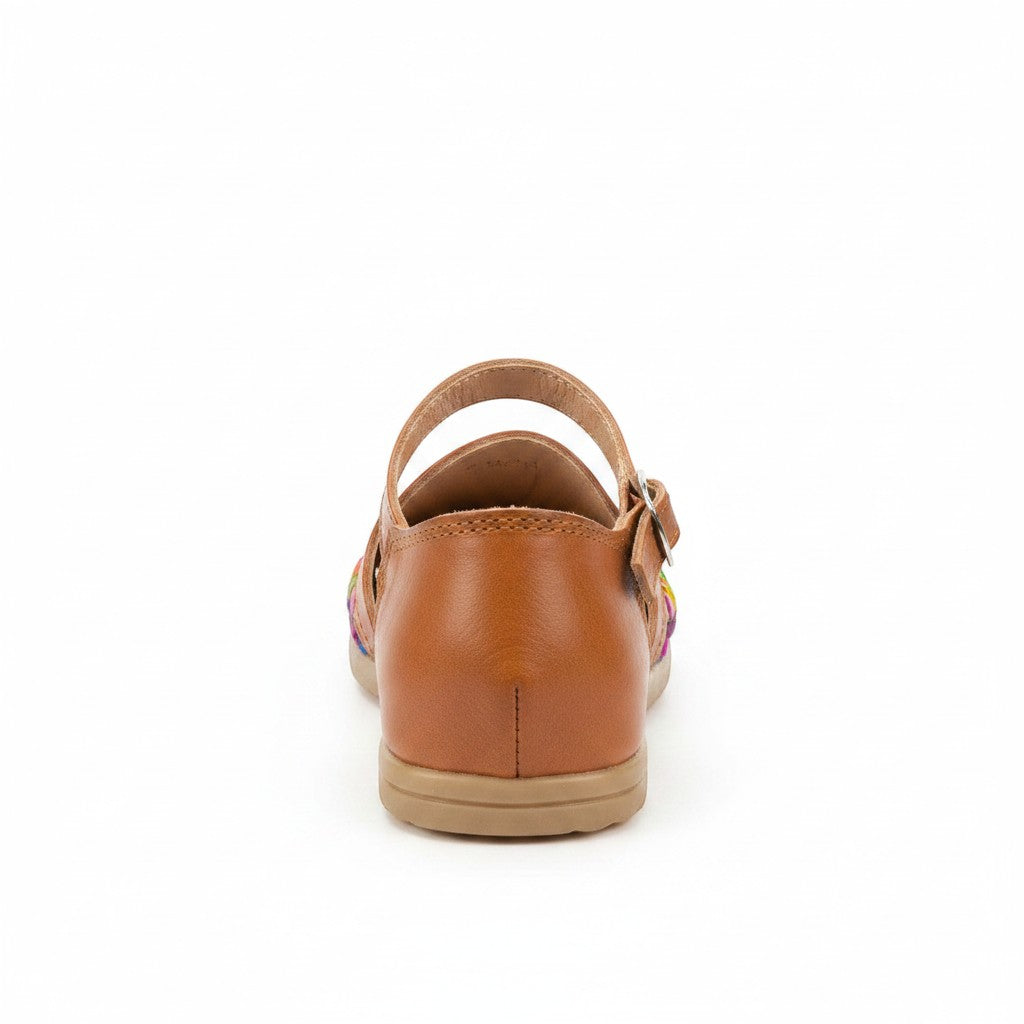 ARTESANALRENVAL tan leather mary jane shoes with colorful woven detail and buckle strap.