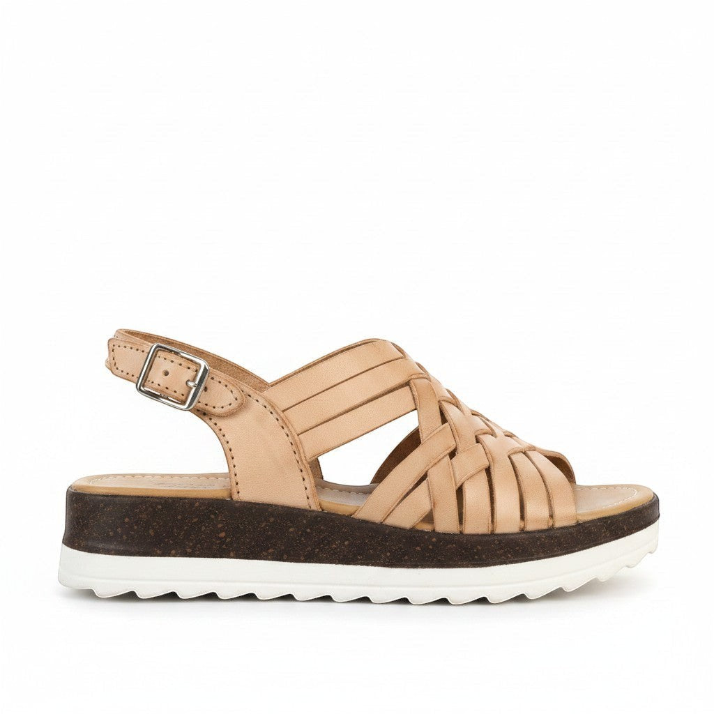 ARTESANALRENVAL tan leather woven platform huarache sandals with buckle strap and cork sole.
