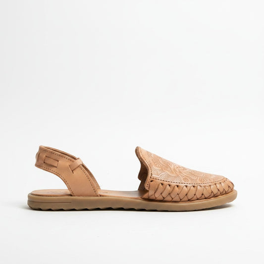 ARTESANALRENVAL natural tan leather huarache sandal with floral engraving and braided detail. Features ankle strap and open toe.