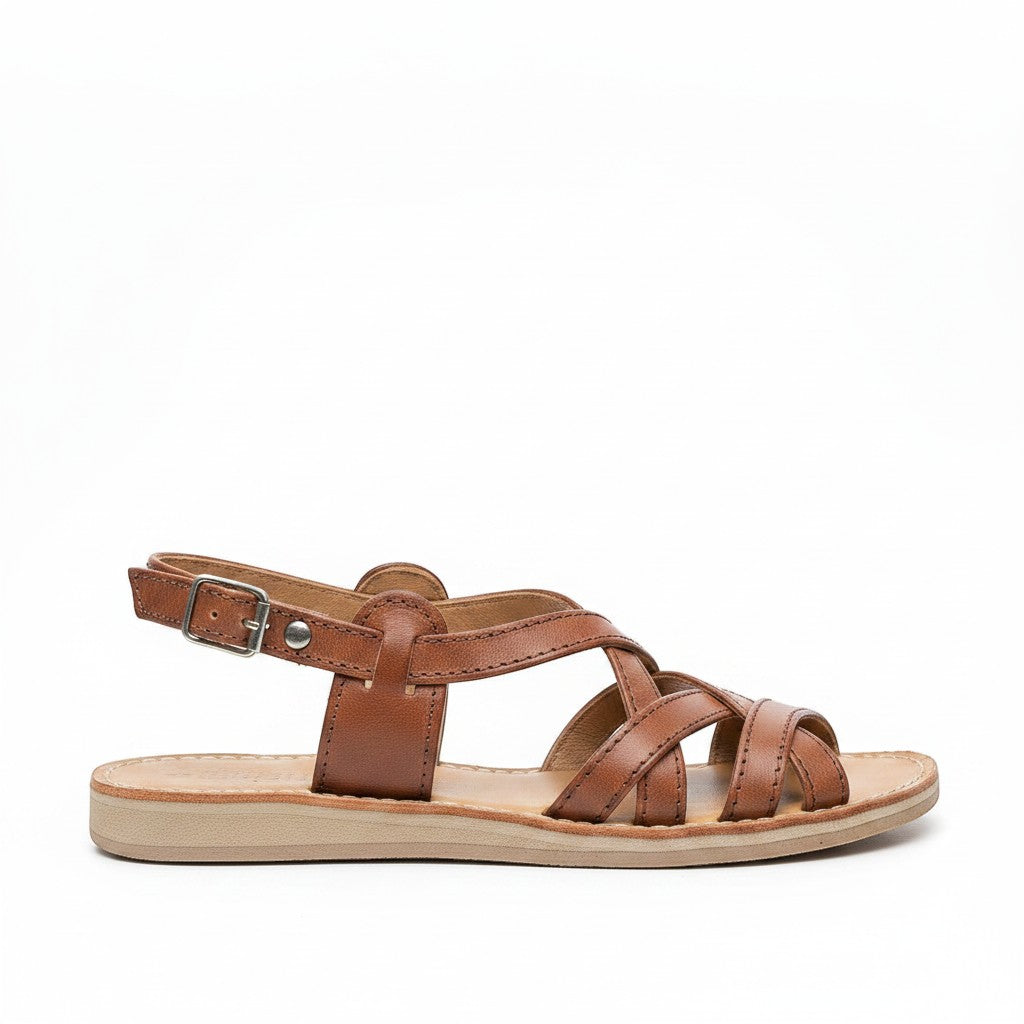 ARTESANALRENVAL tan leather huarache sandals with criss-cross straps and buckle closure.
