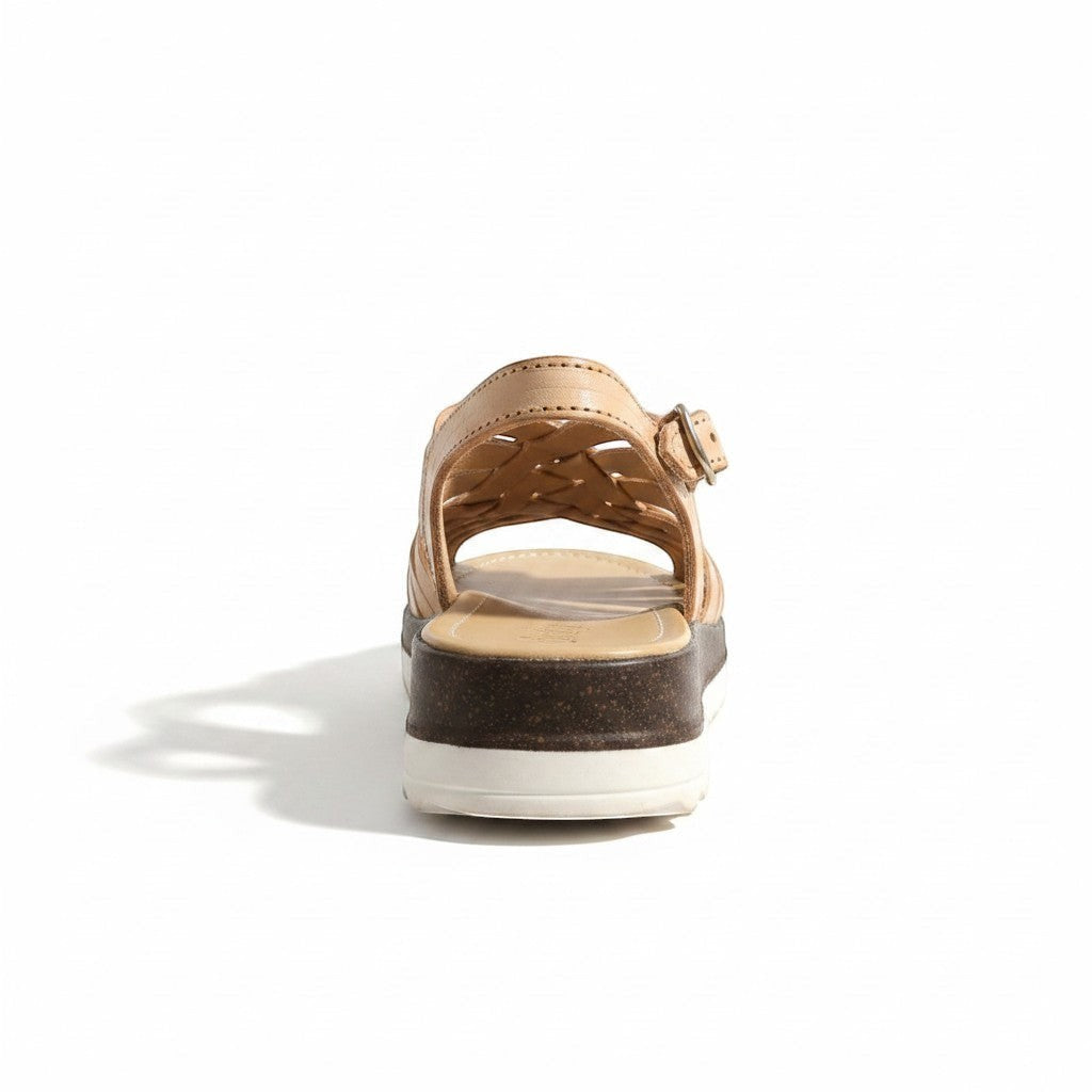 ARTESANALRENVAL tan leather woven huarache sandals with buckle strap and platform sole.