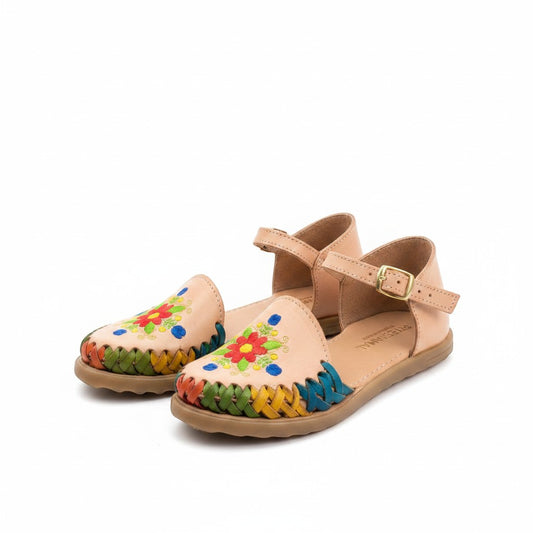 ARTESANALRENVAL tan leather huaraches with colorful floral embroidery and woven trim. Adjustable ankle strap.