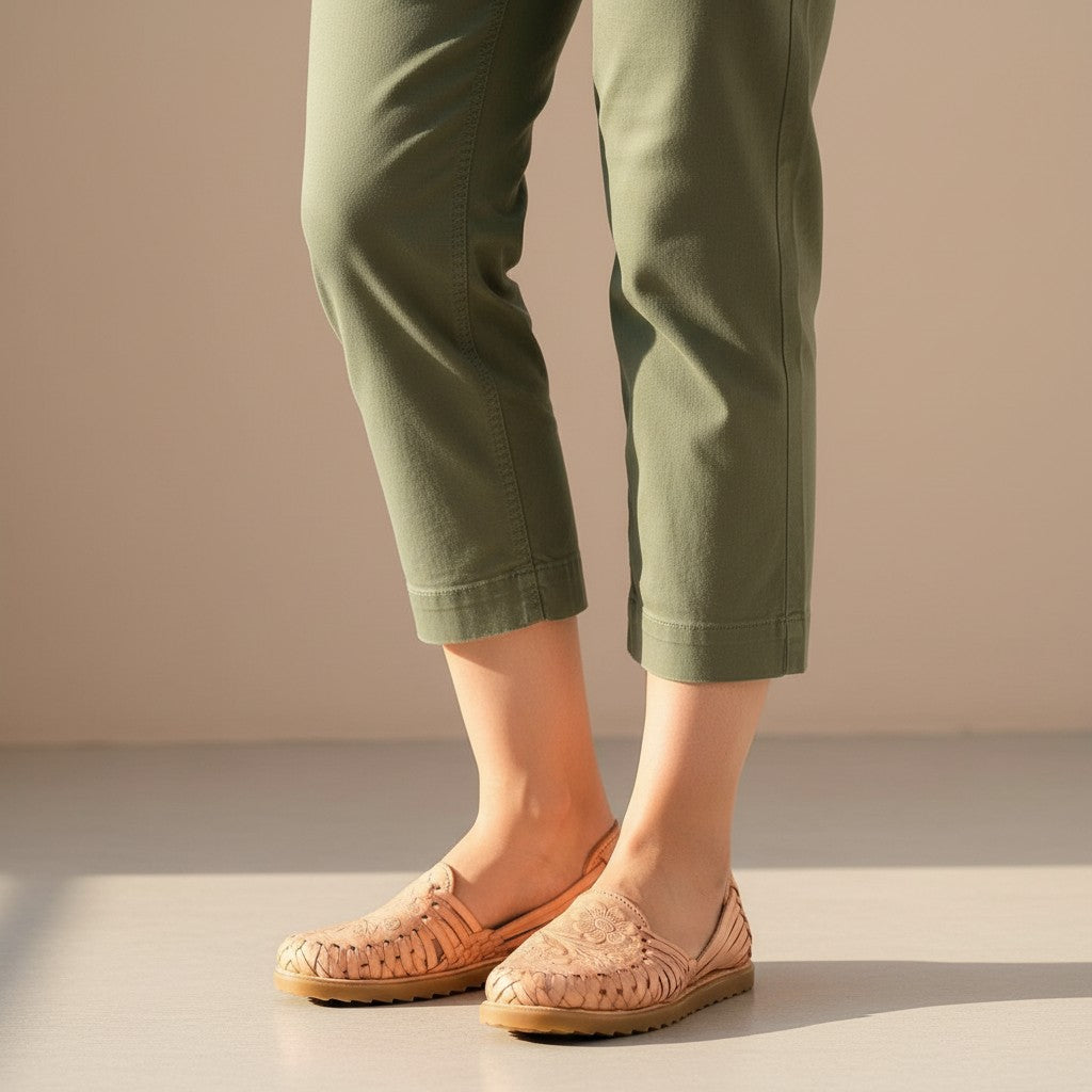 ARTESANALRENVAL tan leather huaraches with intricate floral embossing and woven straps. Handmade Mexican footwear.