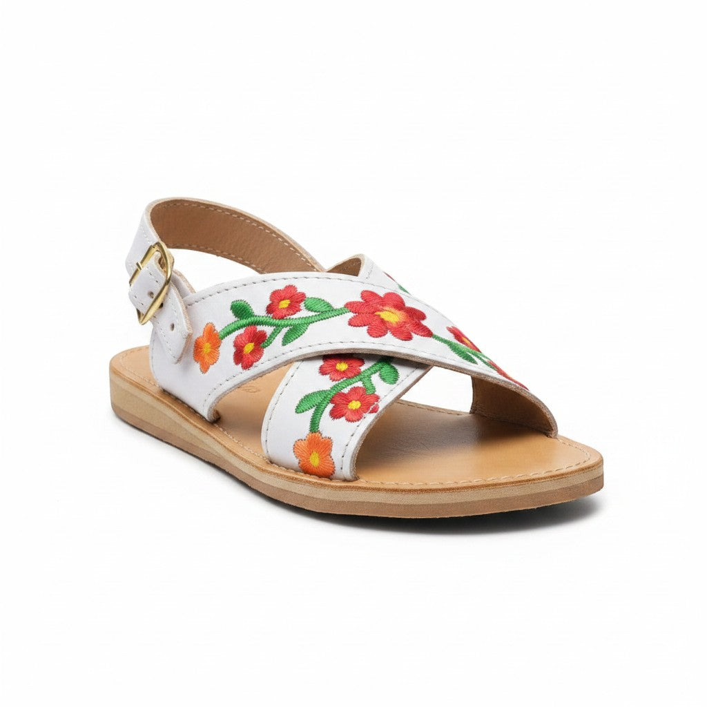 ARTESANALRENVAL white leather huarache sandals with vibrant floral embroidery and gold buckle.