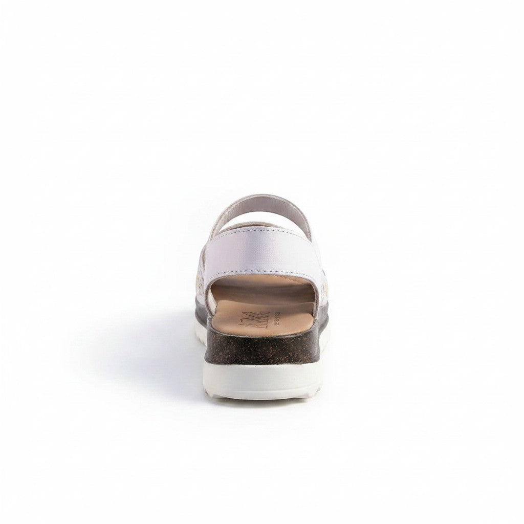 ARTESANALRENVAL white leather huarache sandals with floral cutouts and cork platform sole.