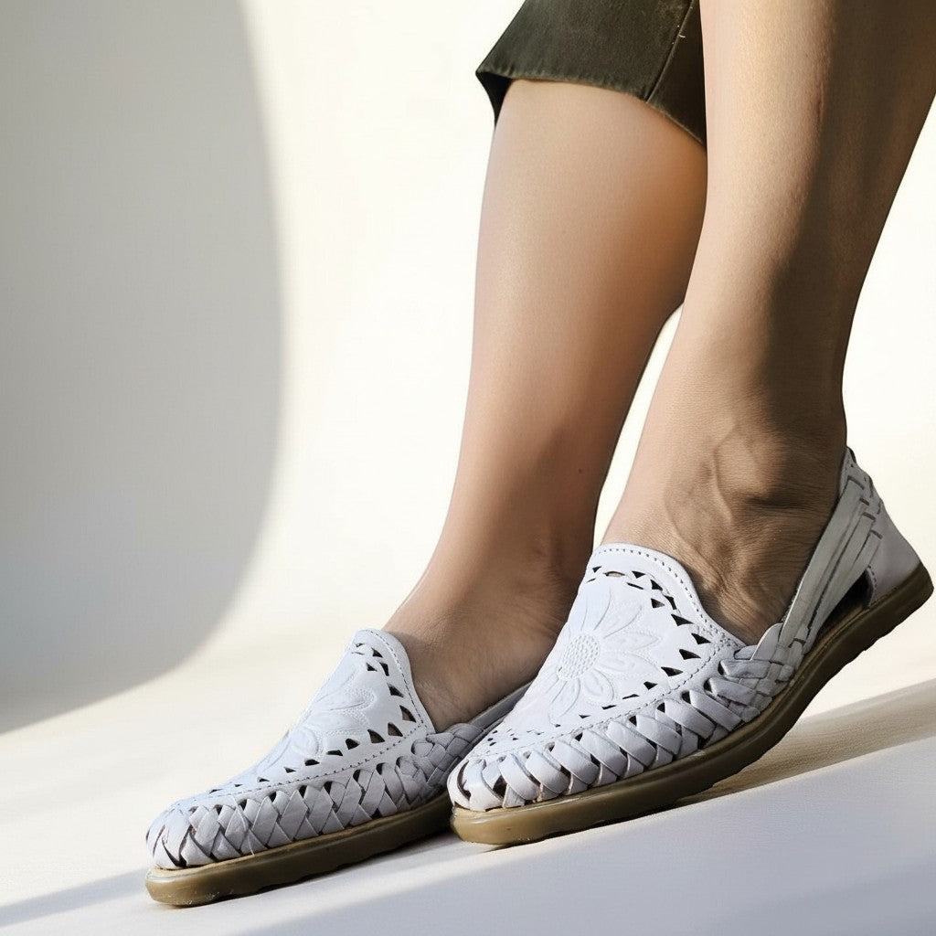 ARTESANALRENVAL white leather huaraches with woven detail and floral embossing. Open-back slip-on style.